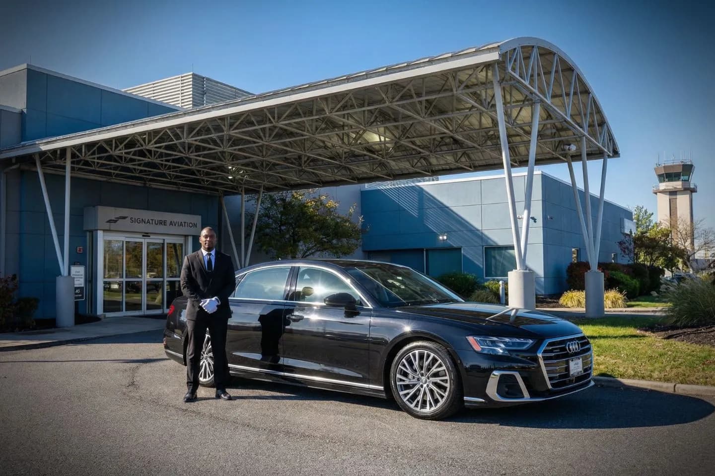 Professional chauffeur opening door for client using Morristown Municipal (MMU) Car Service in Brooklyn